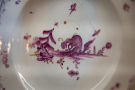A close-up of the bottom of a plate with a fantastic animal motif